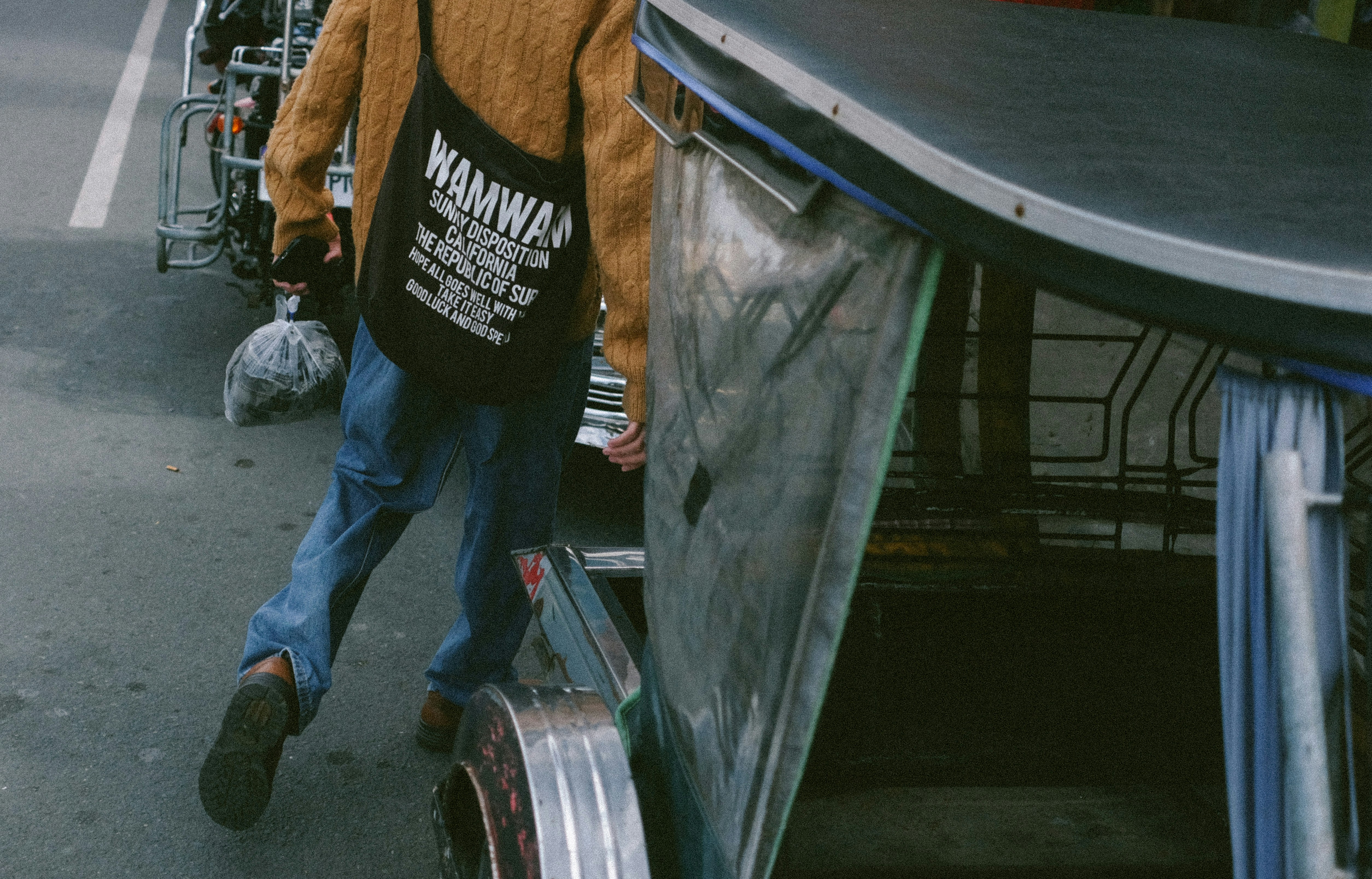 A man walking down a street carrying a suitcase