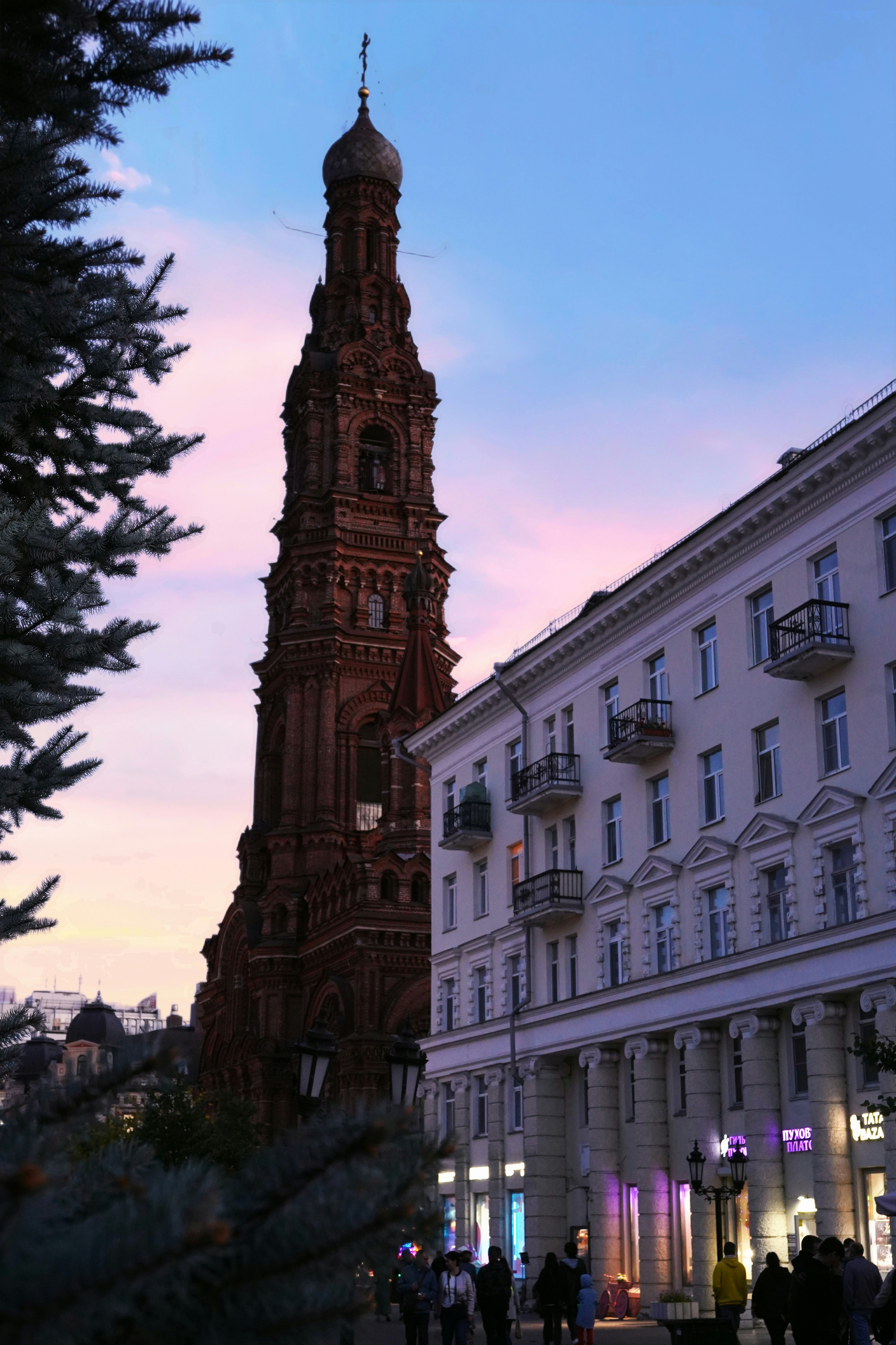 A very tall clock tower towering over a city
