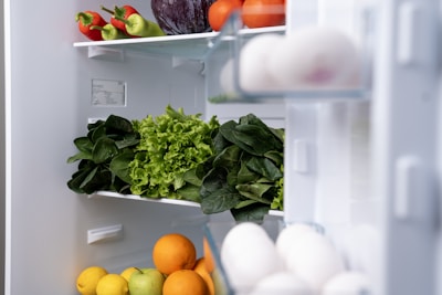 A refrigerator filled with lots of fresh fruits and vegetables