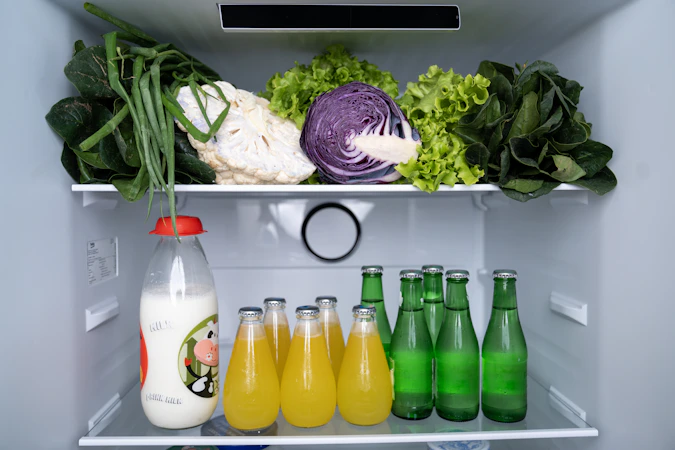 Inside of open modern stainless steel refrigerator with fresh food