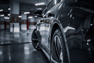 A black and white photo of a car in a parking garage