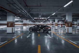 A black car parked in a parking garage