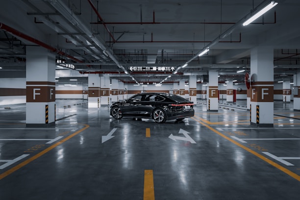 A black car parked in a parking garage