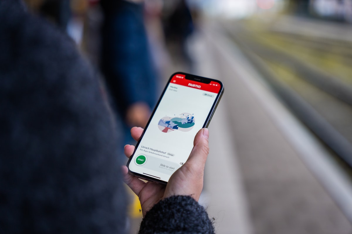 A person holding a cell phone in their hand