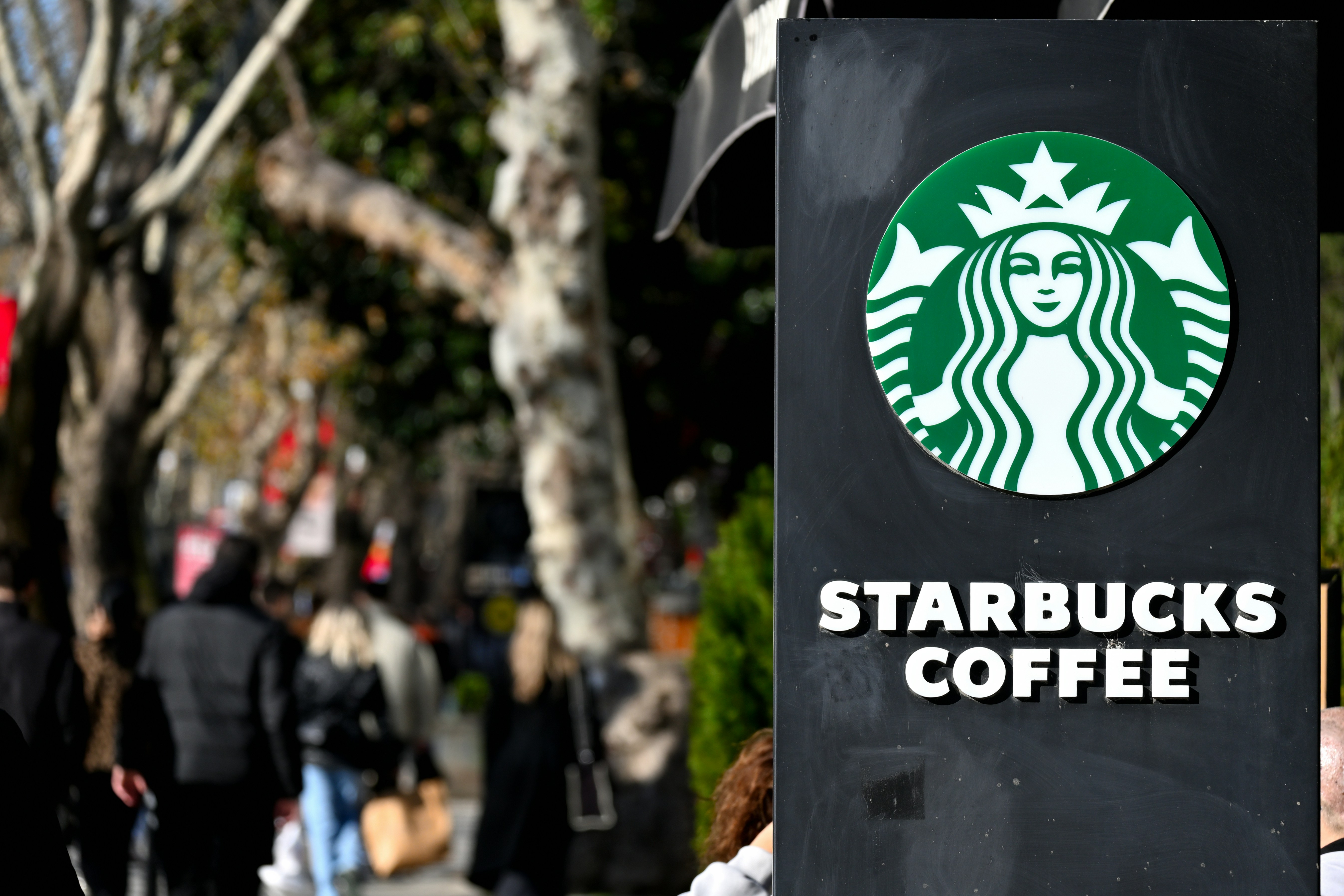 Starbucks sign with steady customer traffic, reflecting increased store activity and sales growth