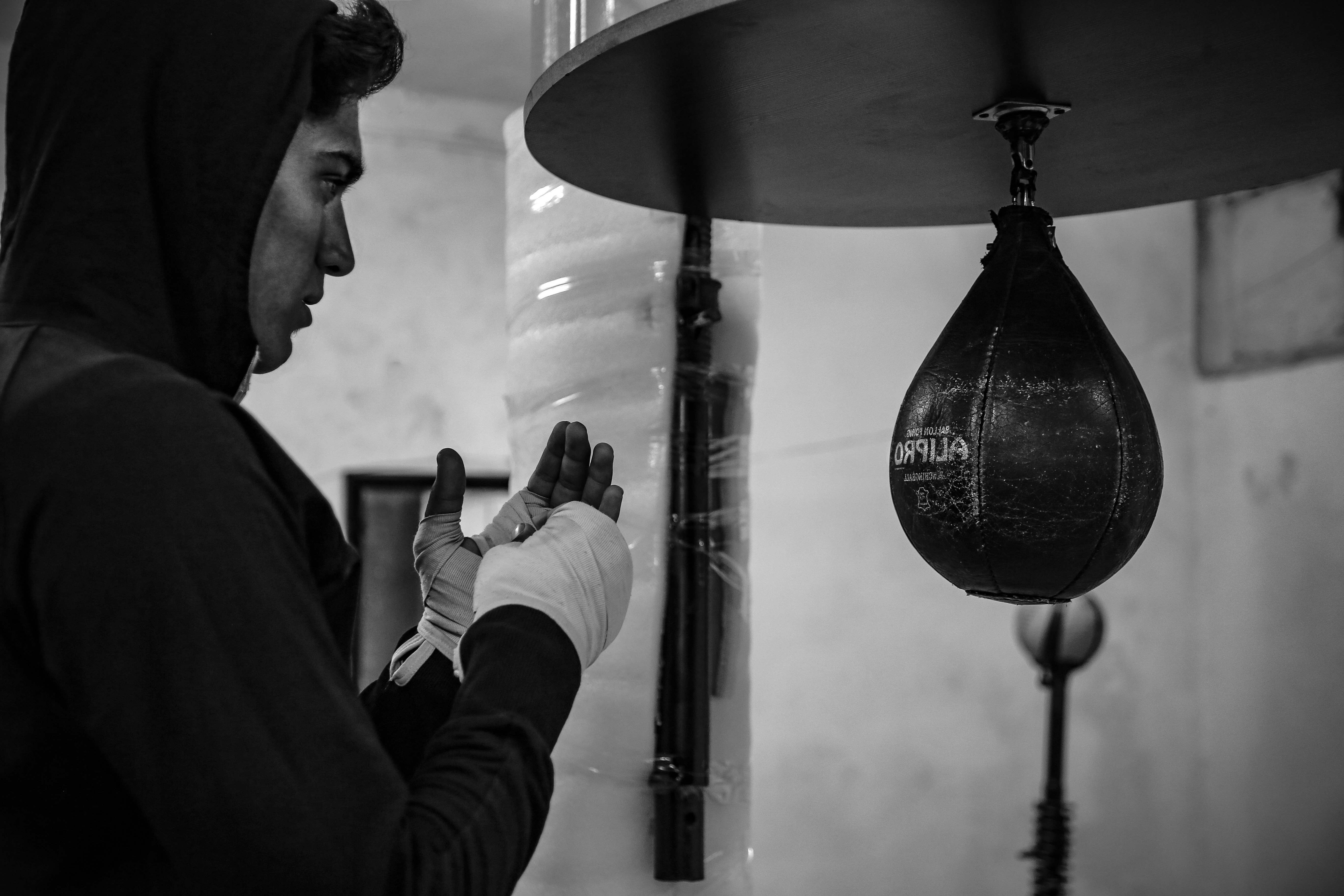 A man in a hoodie looking at his cell phone