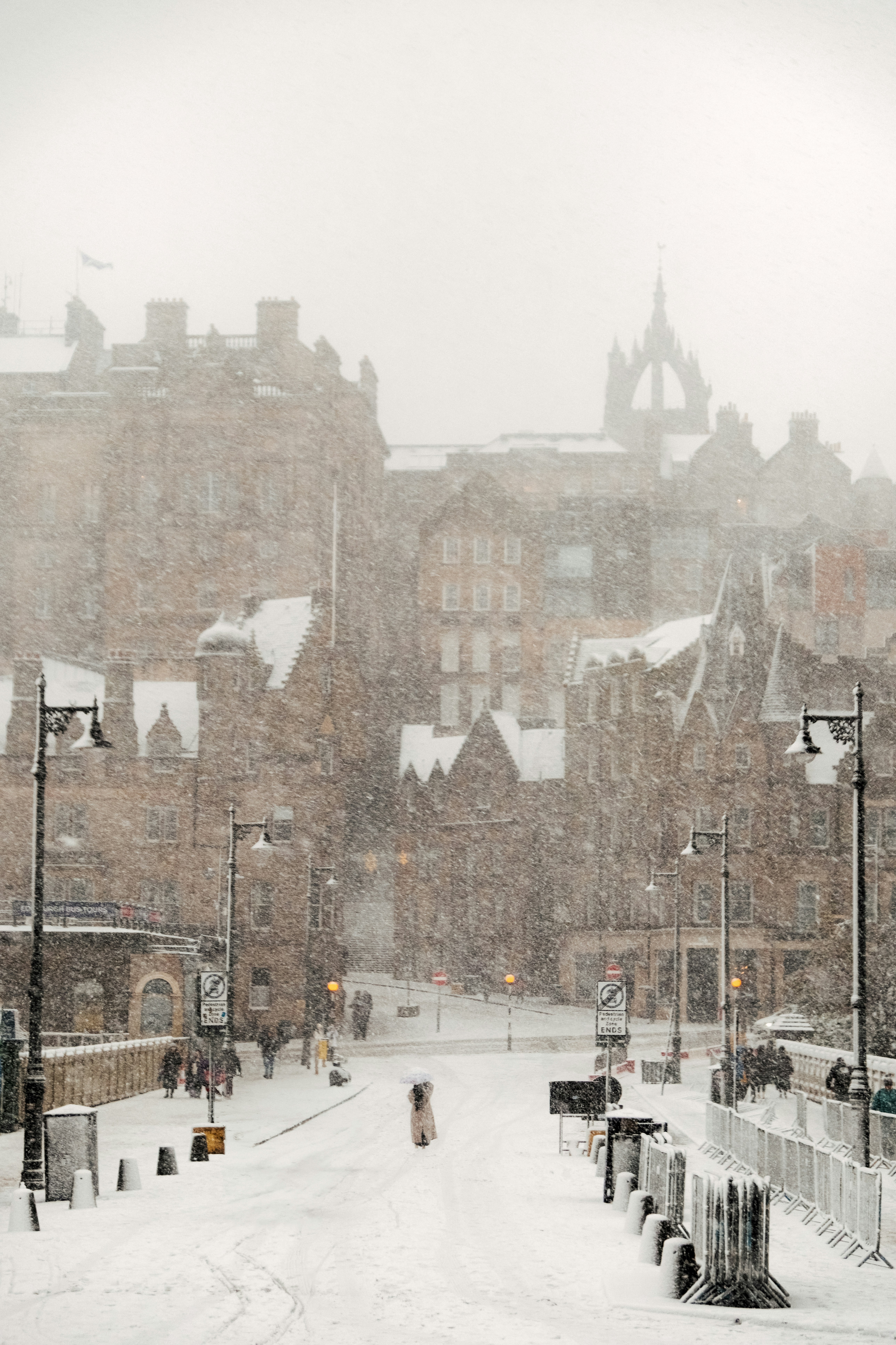 A city street is covered in snow during a winter storm