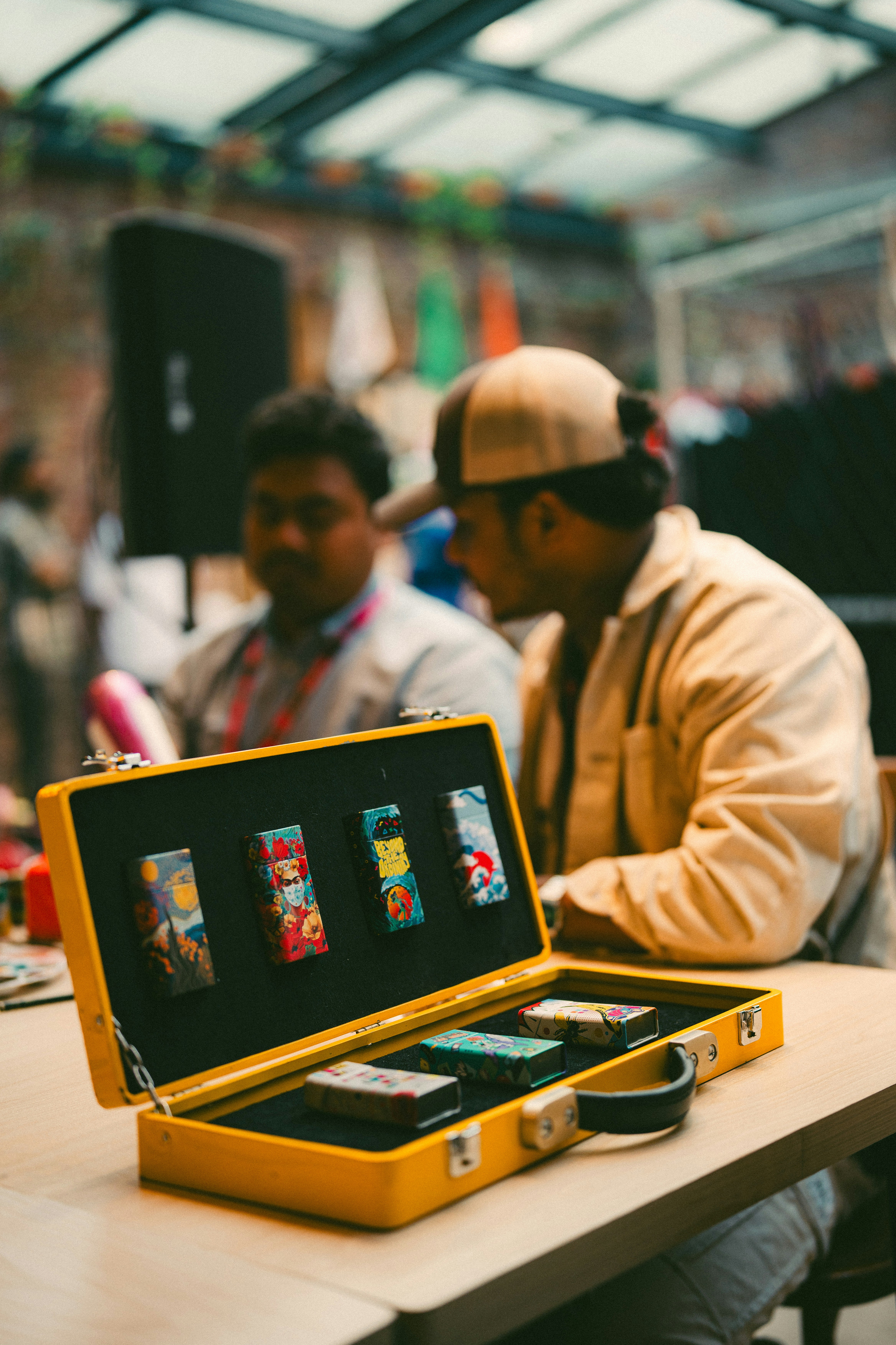 A man sitting at a table with a yellow case