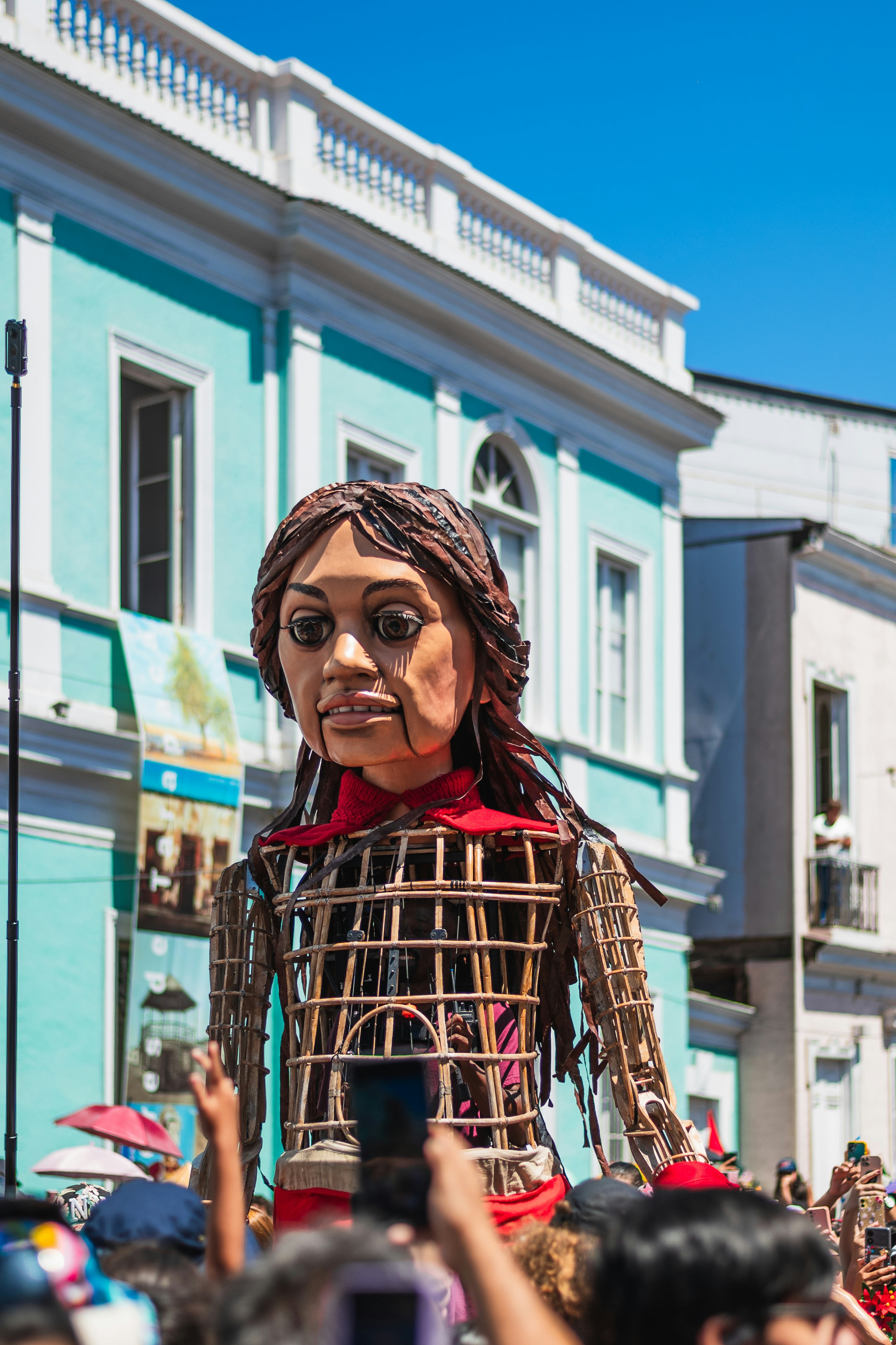 A puppet is being carried by a crowd of people