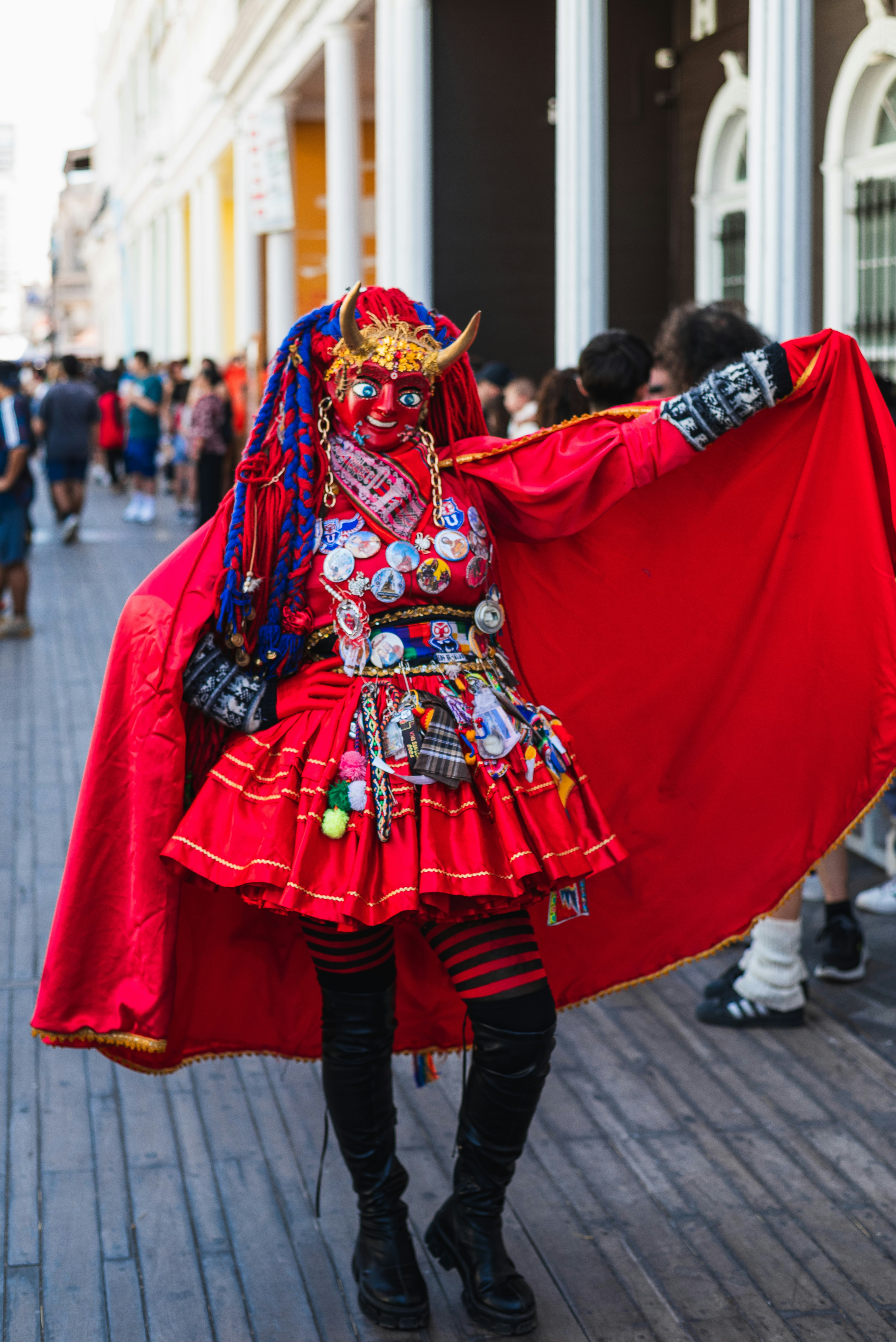A woman in a red costume is holding a red cloth