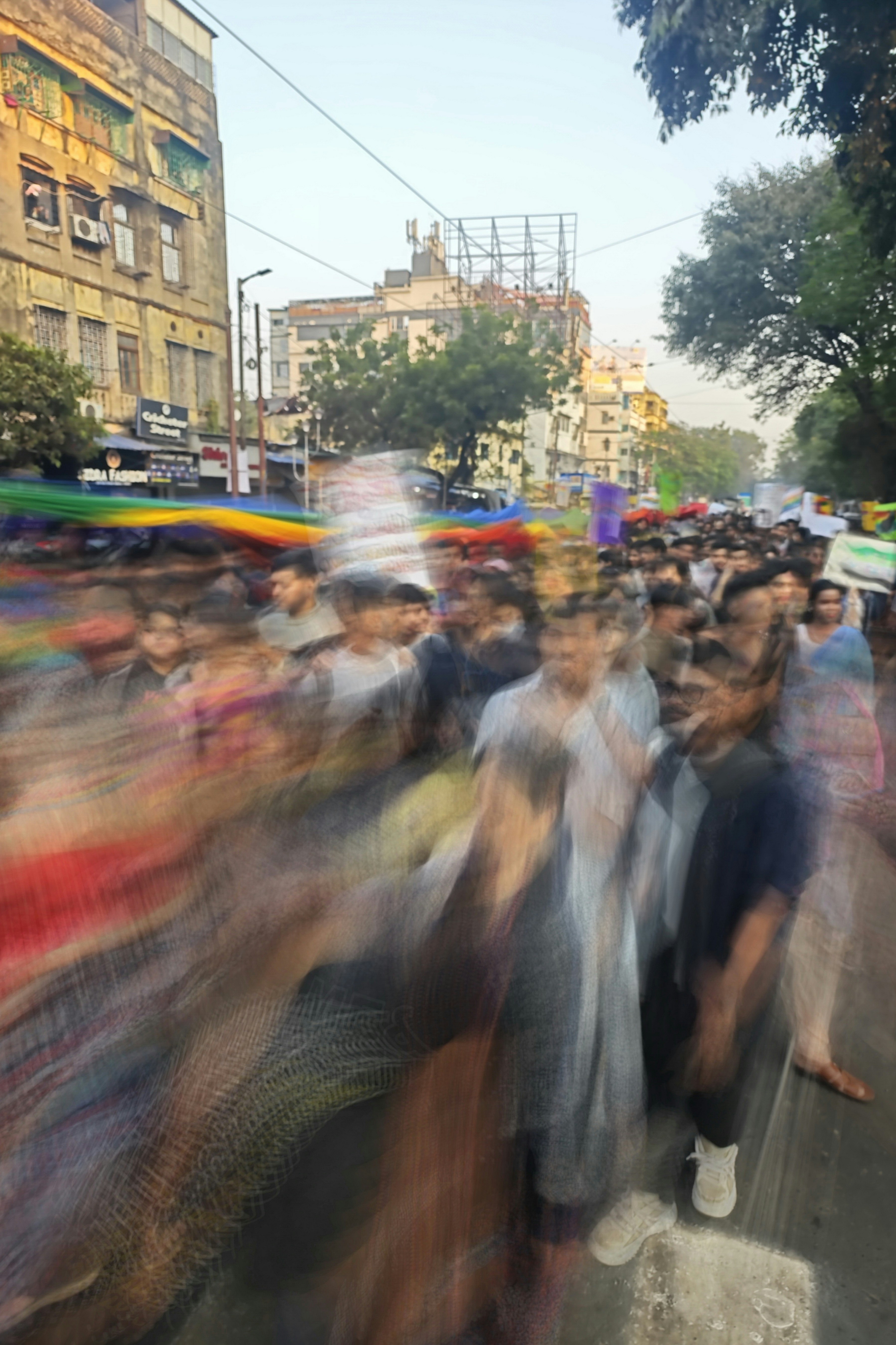 A large group of people walking down a street