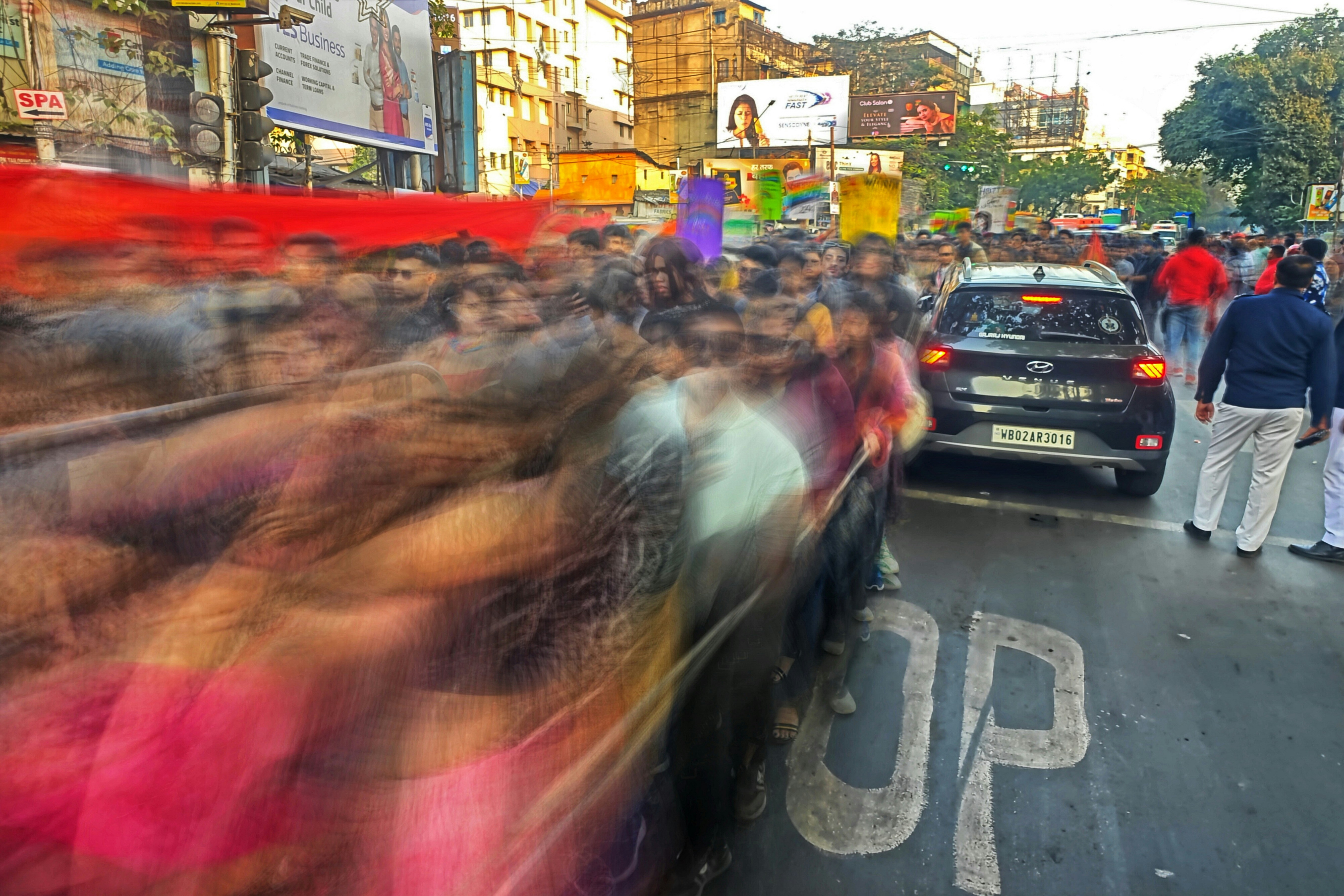 A crowd of people standing on the side of a road
