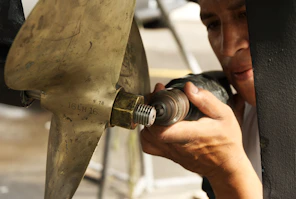 A man is working on a piece of metal