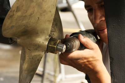 A man is working on a piece of metal