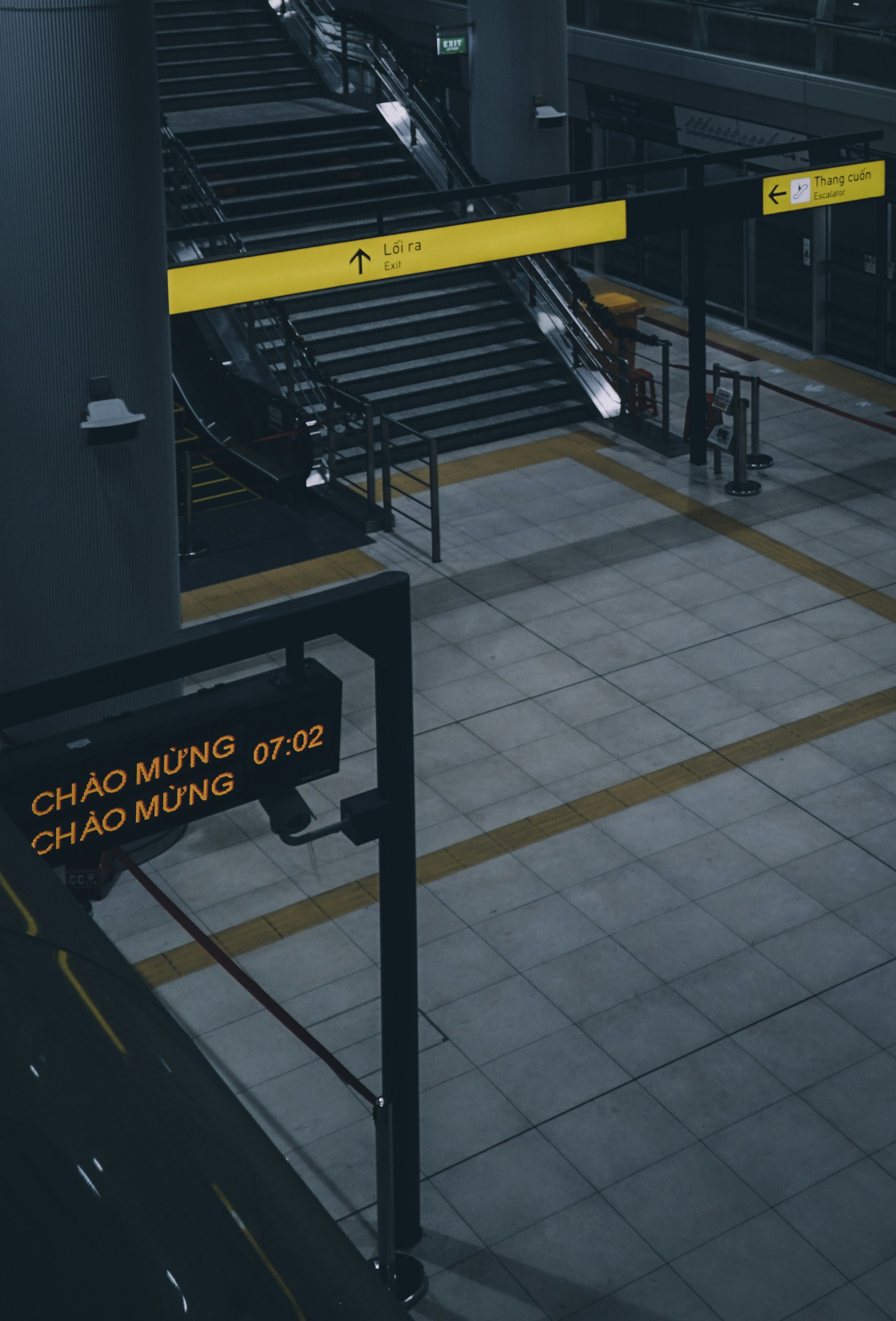 A train station with a yellow and black sign