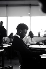 A man sitting at a desk using a laptop computer