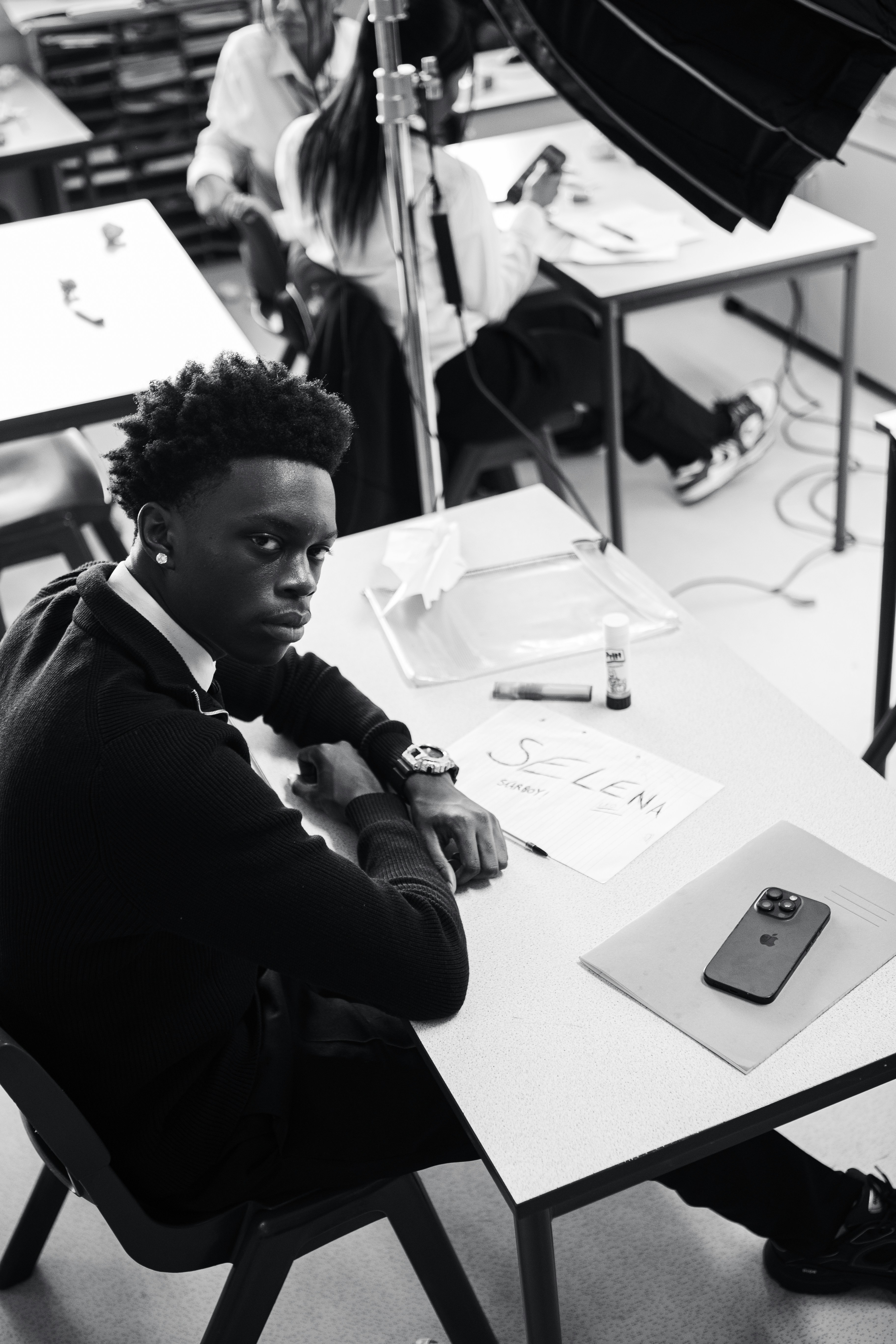 A black and white photo of a man sitting at a desk