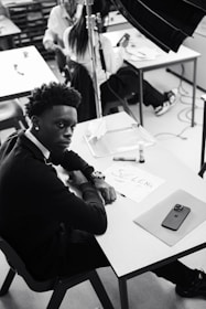A black and white photo of a man sitting at a desk