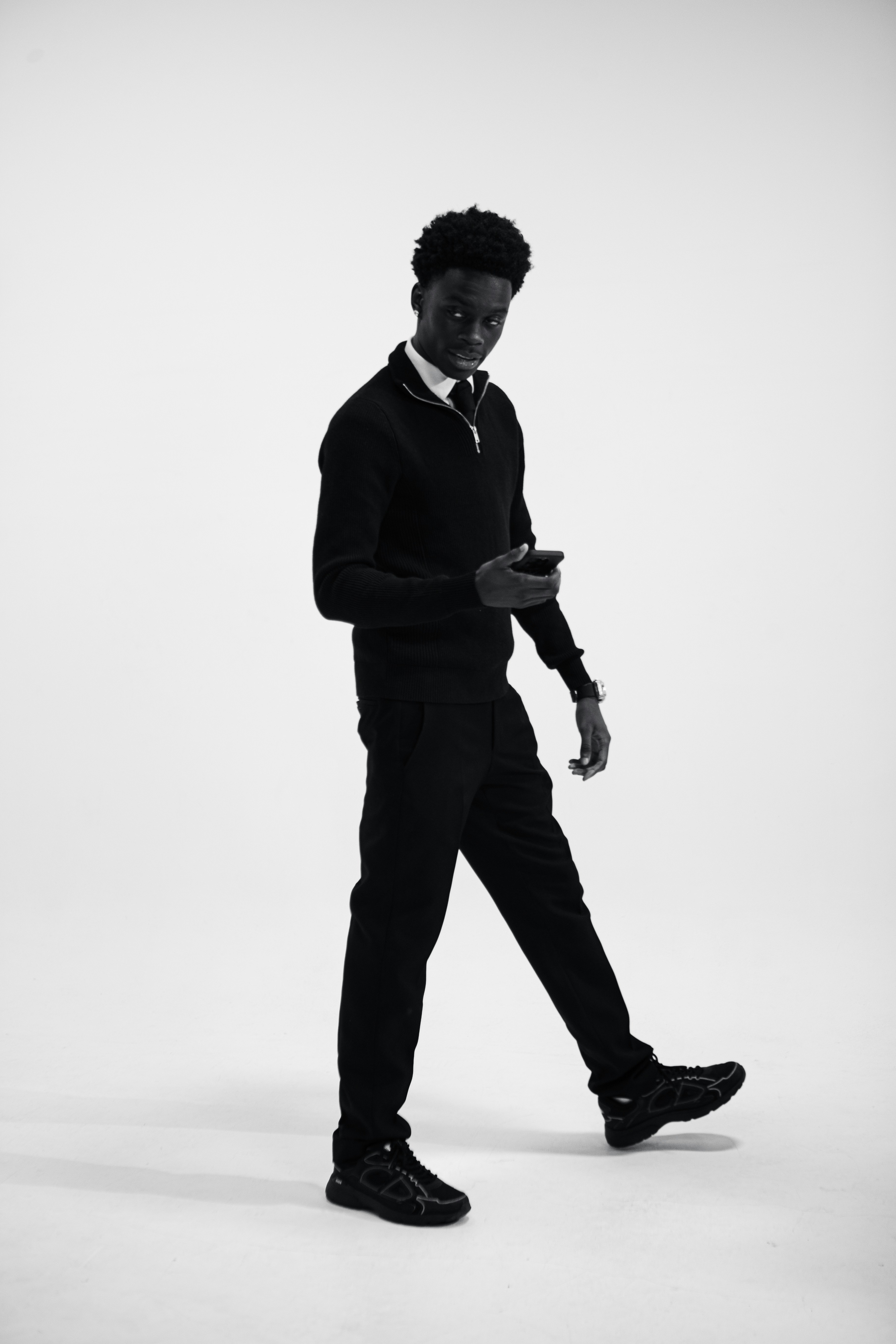 A man in a suit and tie walking