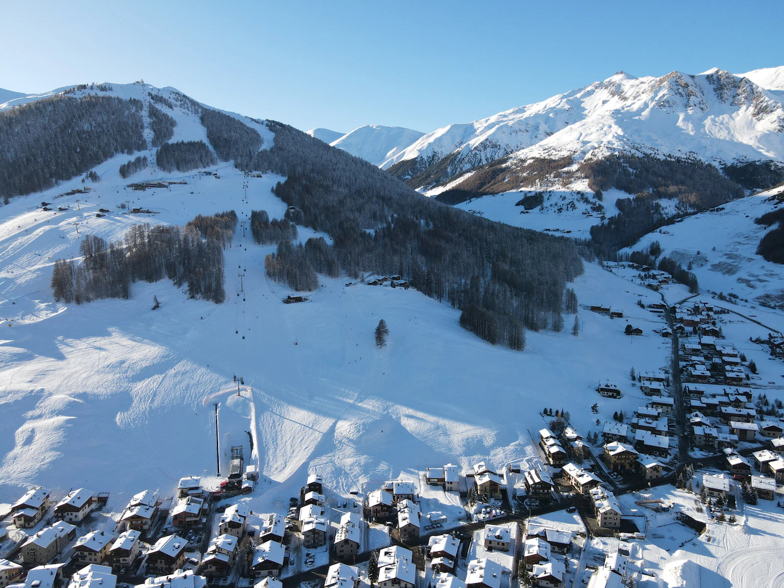 A snow covered mountain with a village in the foreground