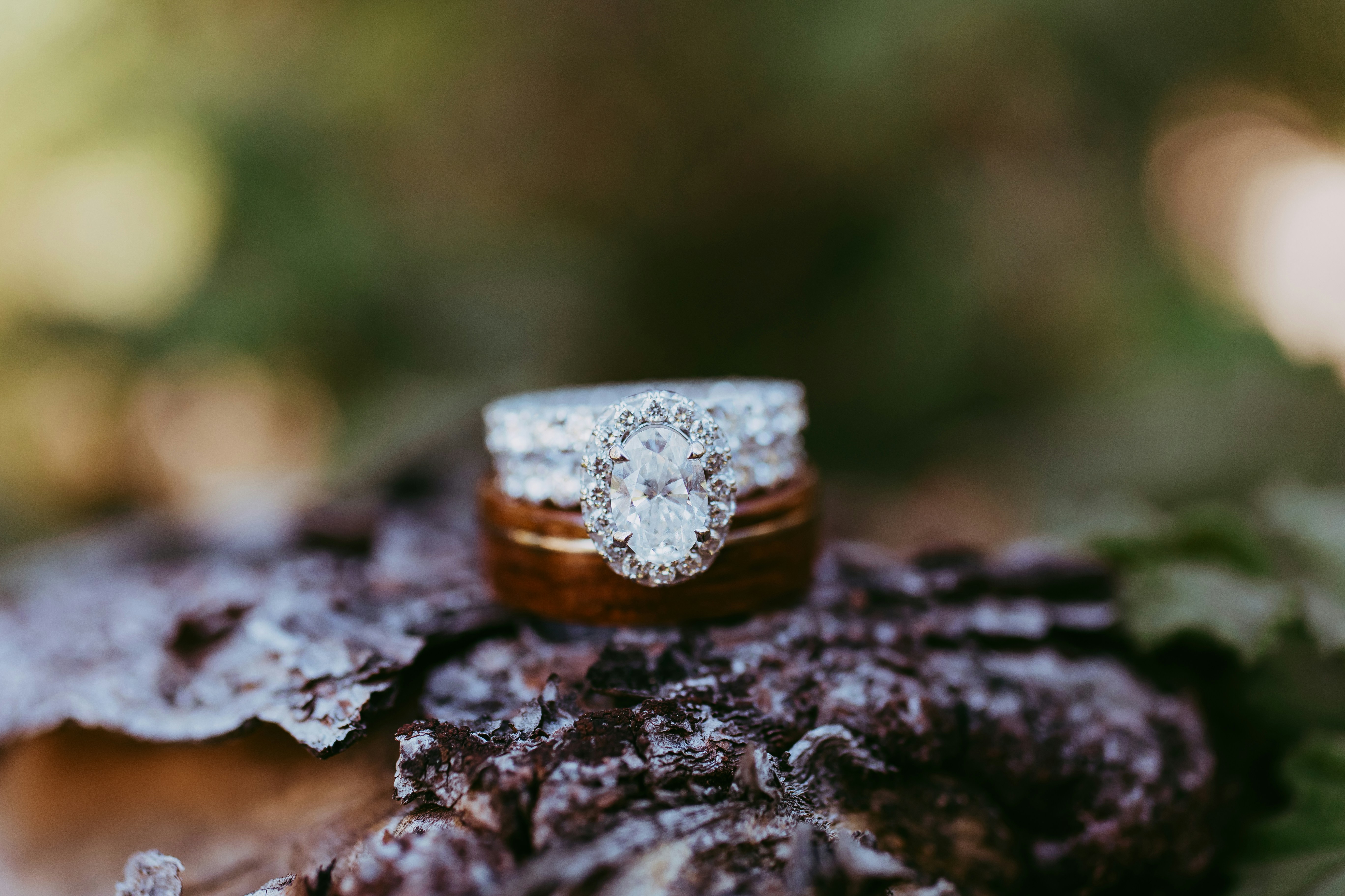 A couple of wedding rings sitting on top of a wooden table
