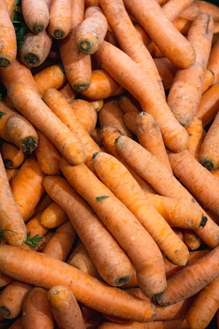 A pile of carrots sitting next to each other