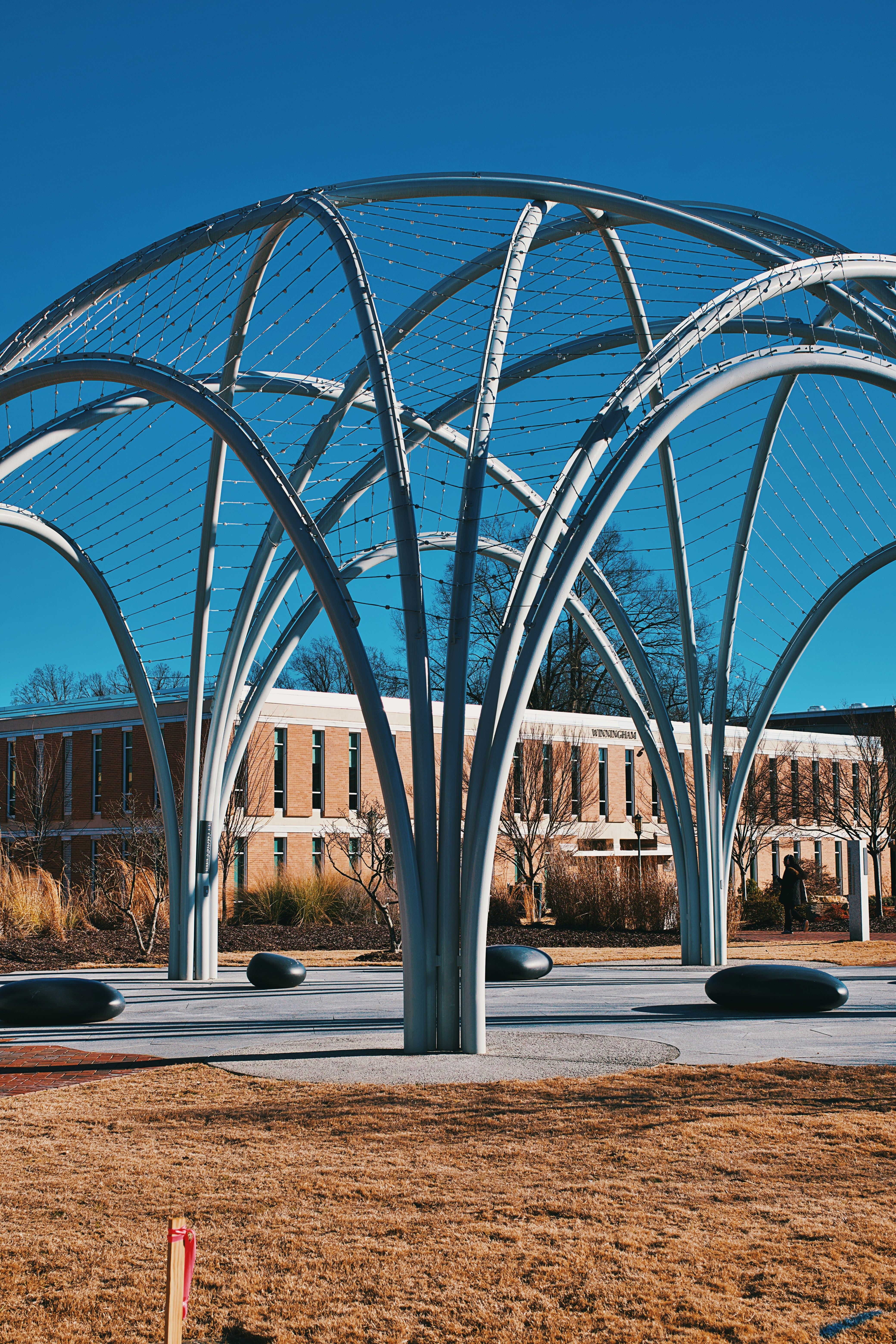 A large metal structure sitting in the middle of a field