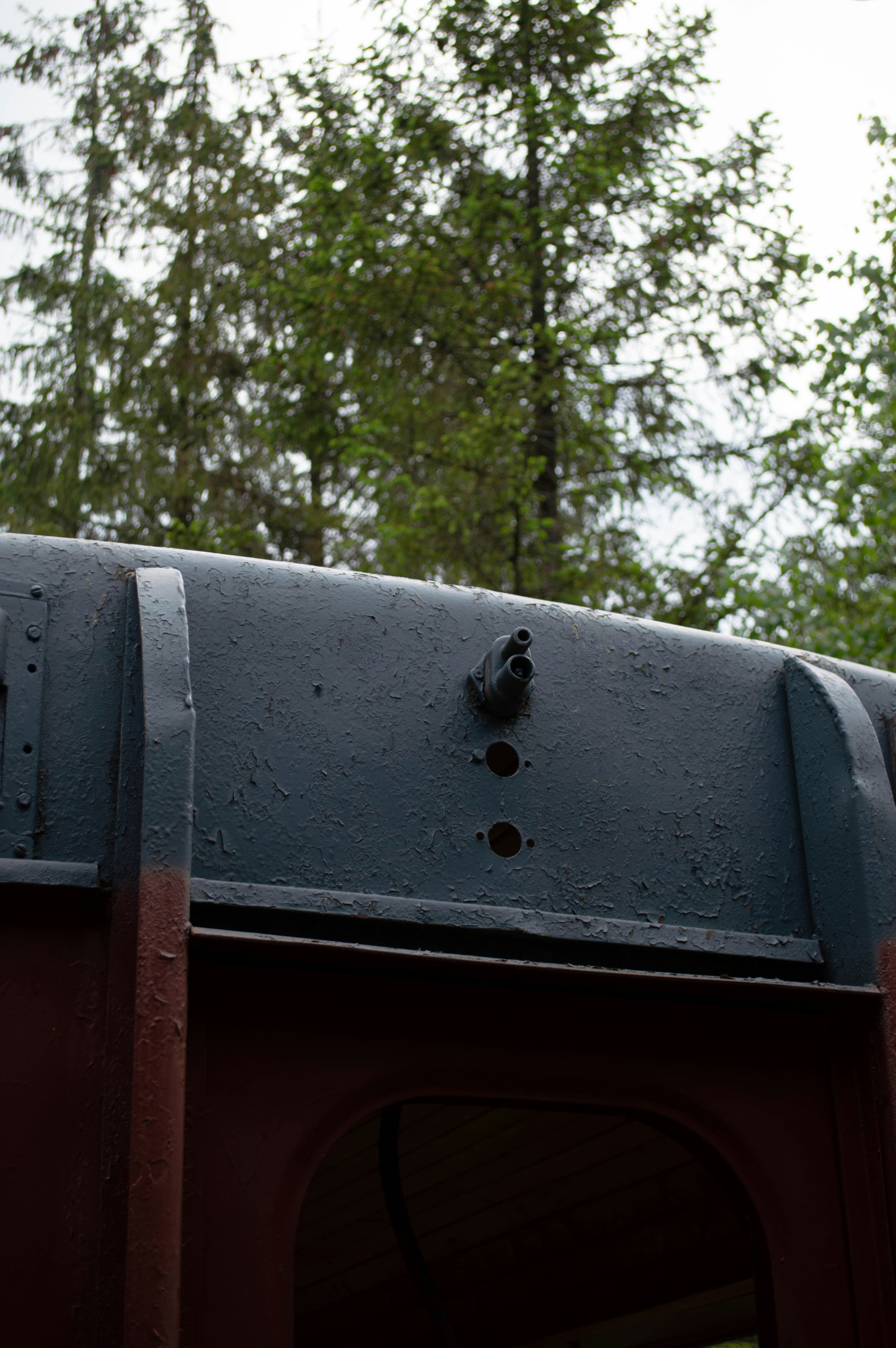 A close up of a train with trees in the background
