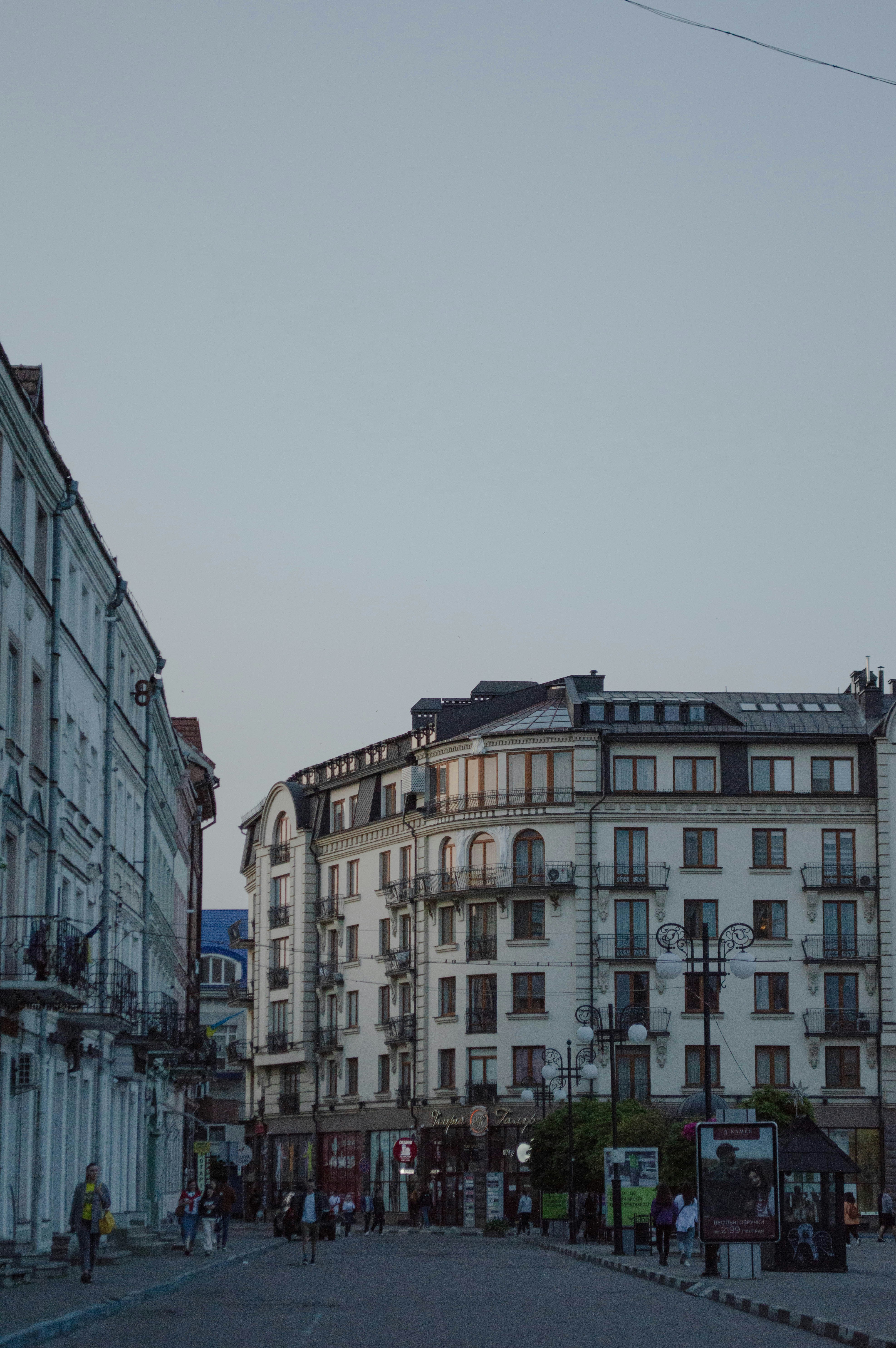 A city street lined with tall white buildings