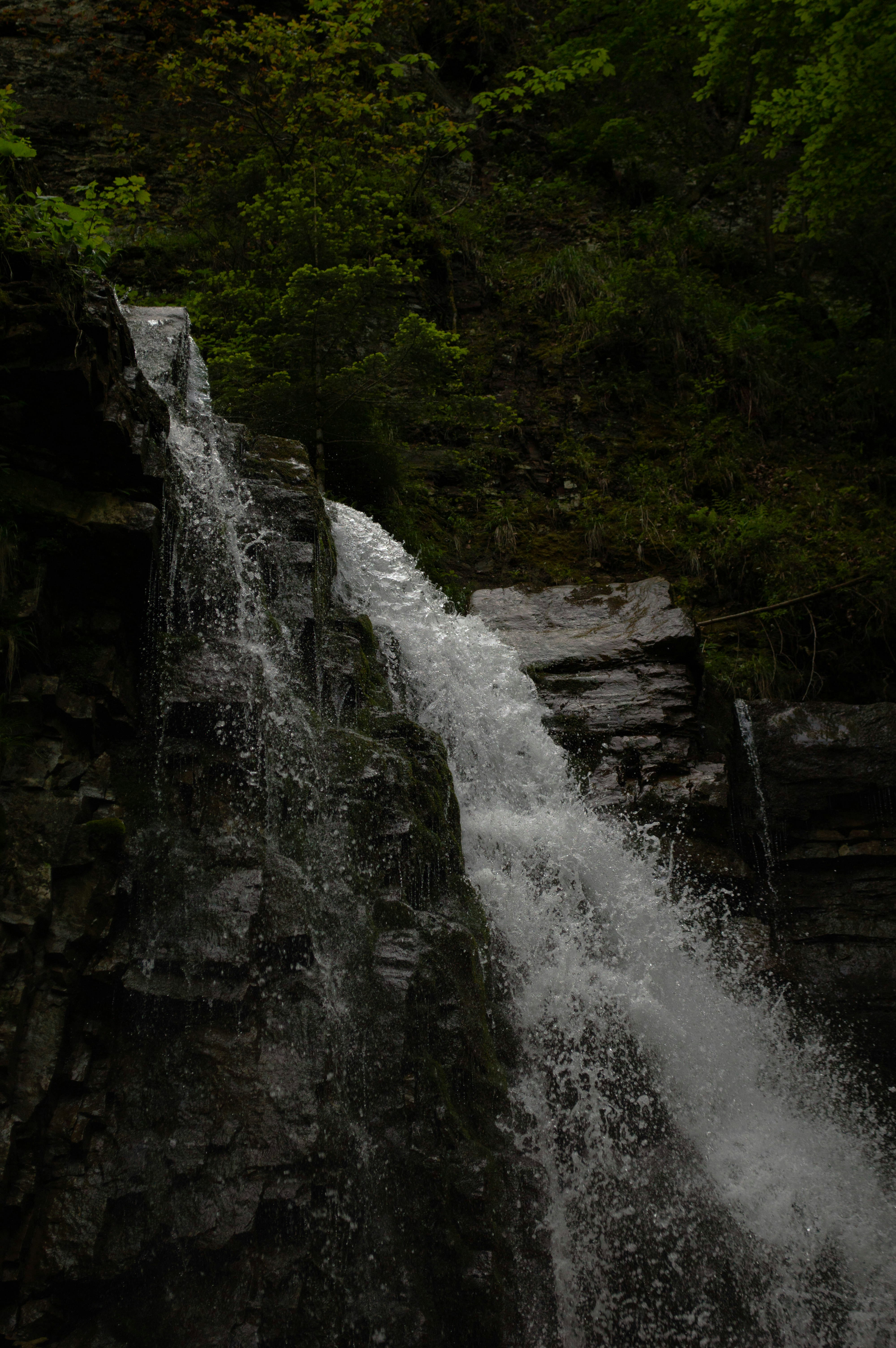 A waterfall with a man standing on top of it