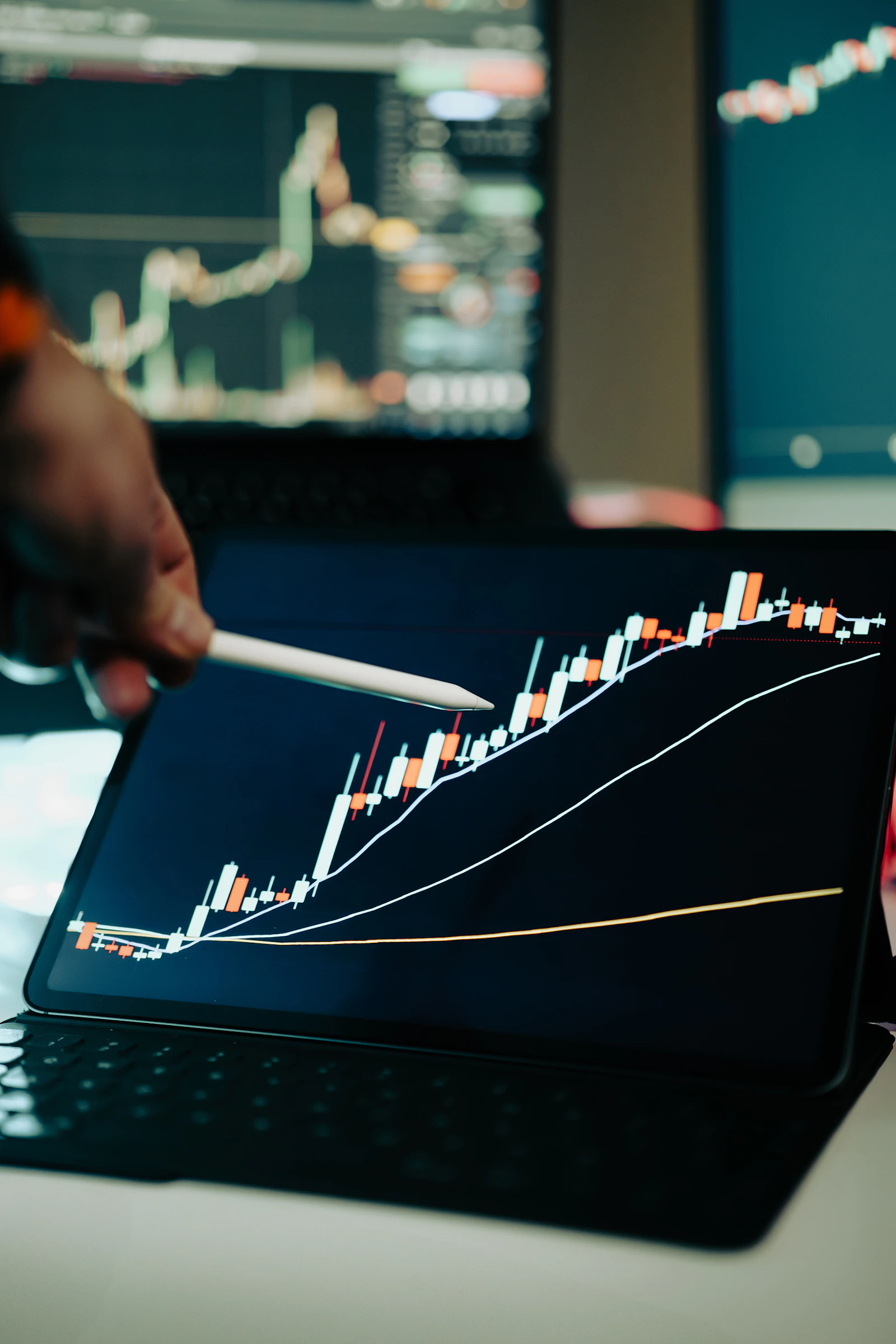 A person reviewing financial market charts on a laptop