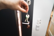 A person is holding a key to a door