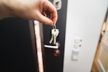 A person is holding a key to a door