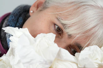 A close up of a person with white hair