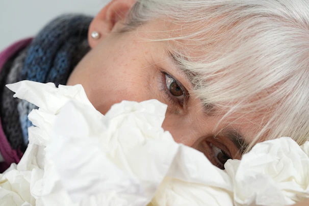 A close up of a person with white hair