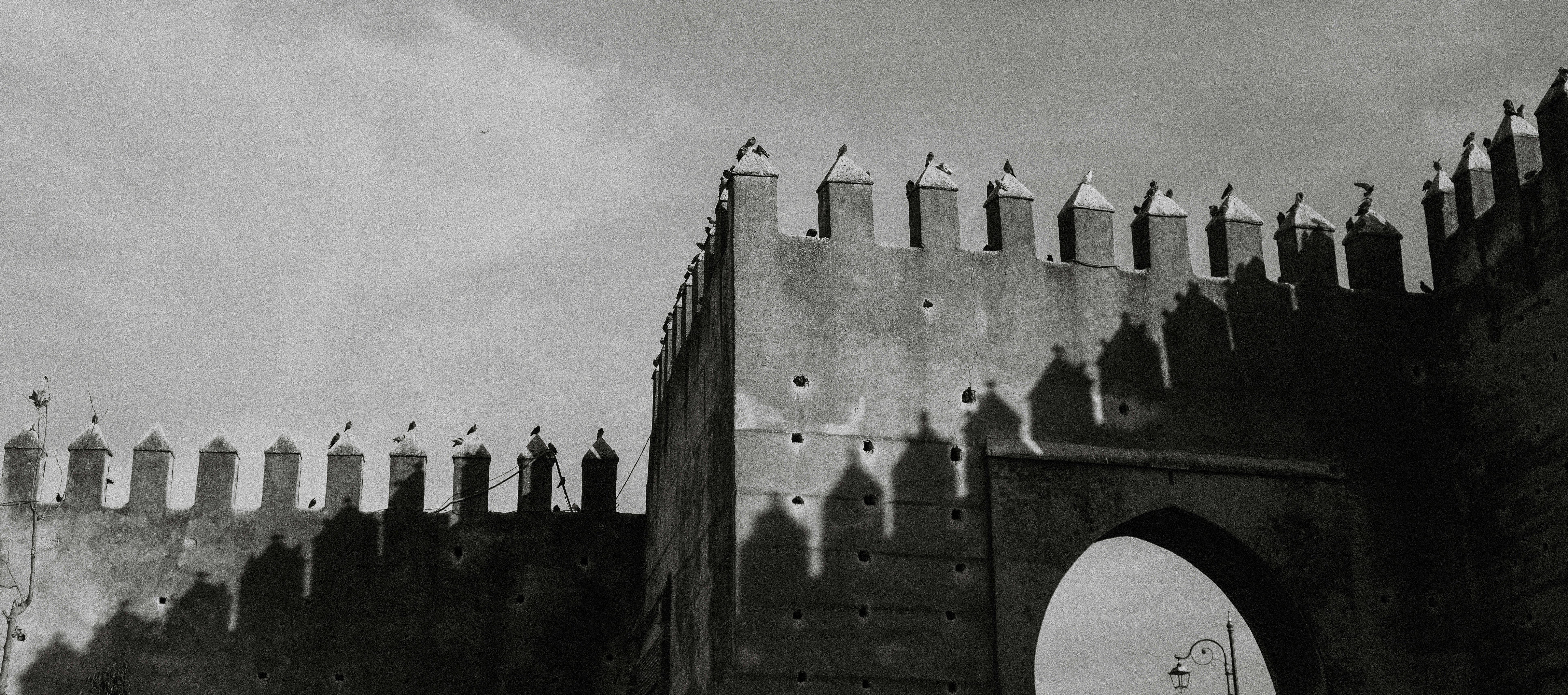 A black and white photo of a gate