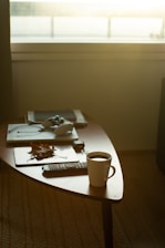 A coffee cup sitting on top of a wooden table