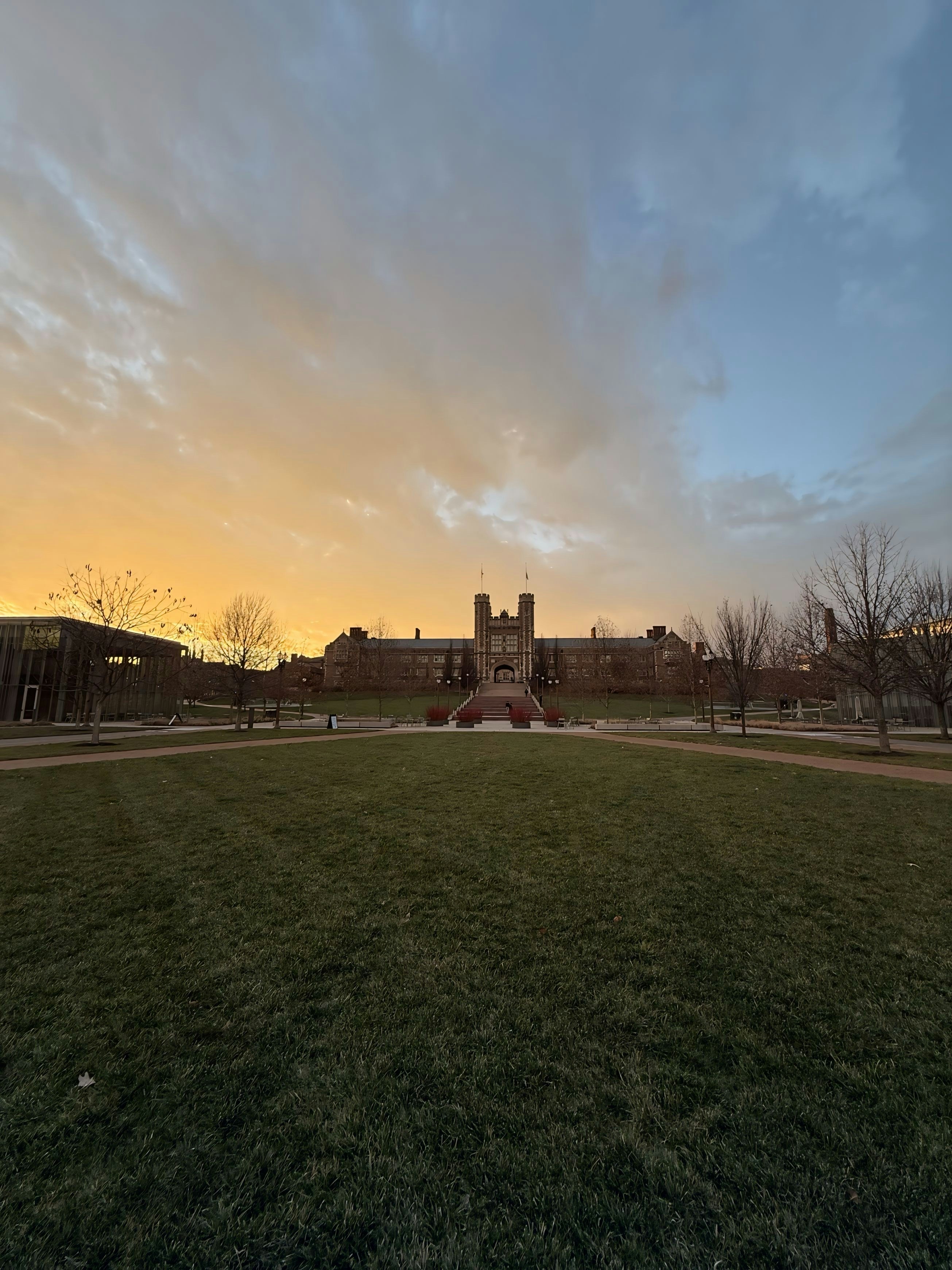 A grassy field with a building in the background
