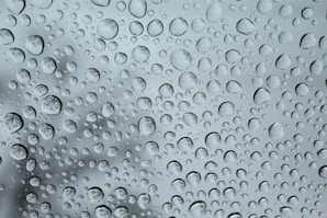 A close up of a rain covered window