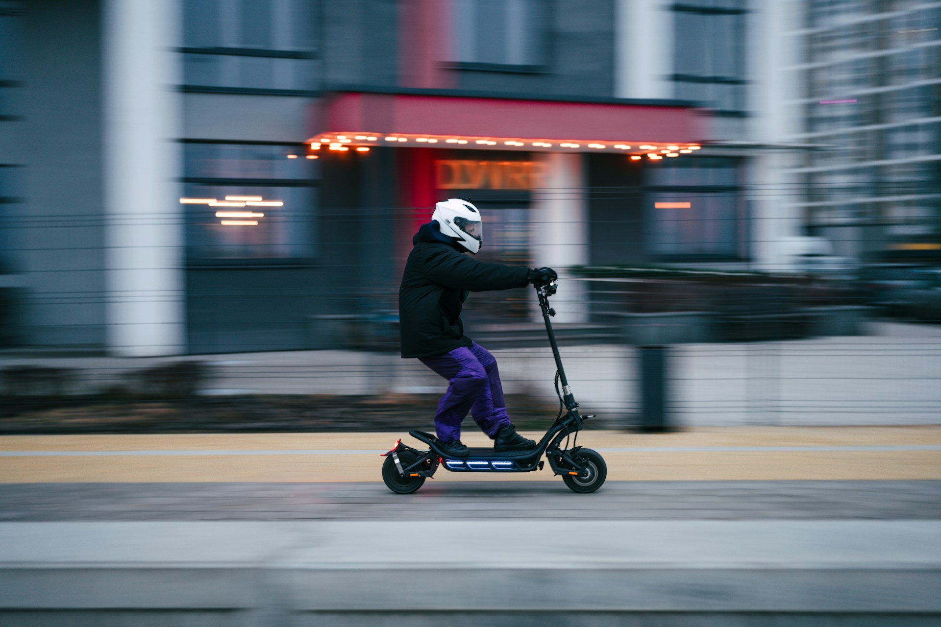 A person riding a scooter on a city street