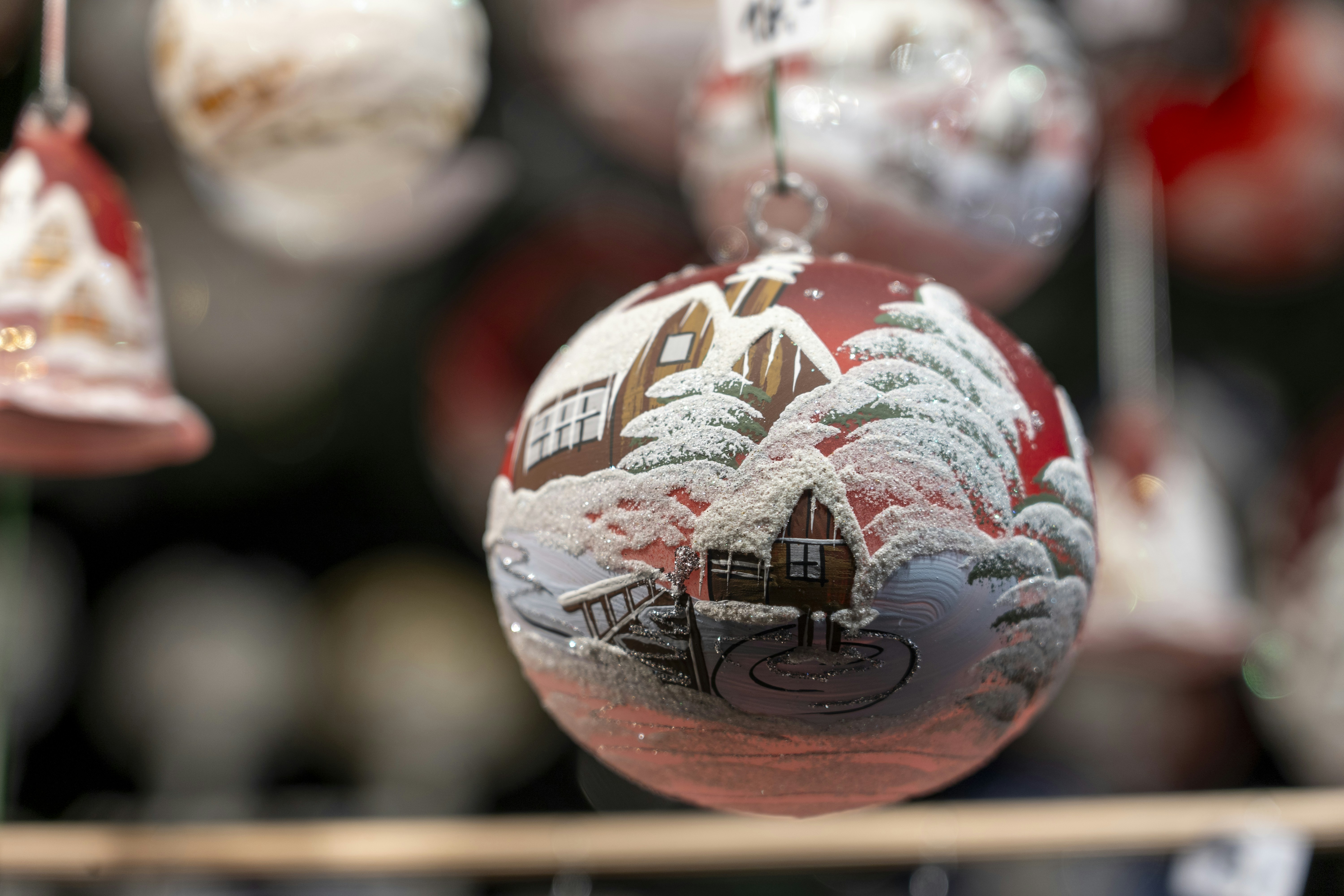 A close up of a christmas ornament hanging from a string