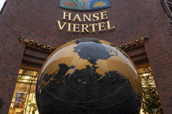 A building with a giant globe in front of it