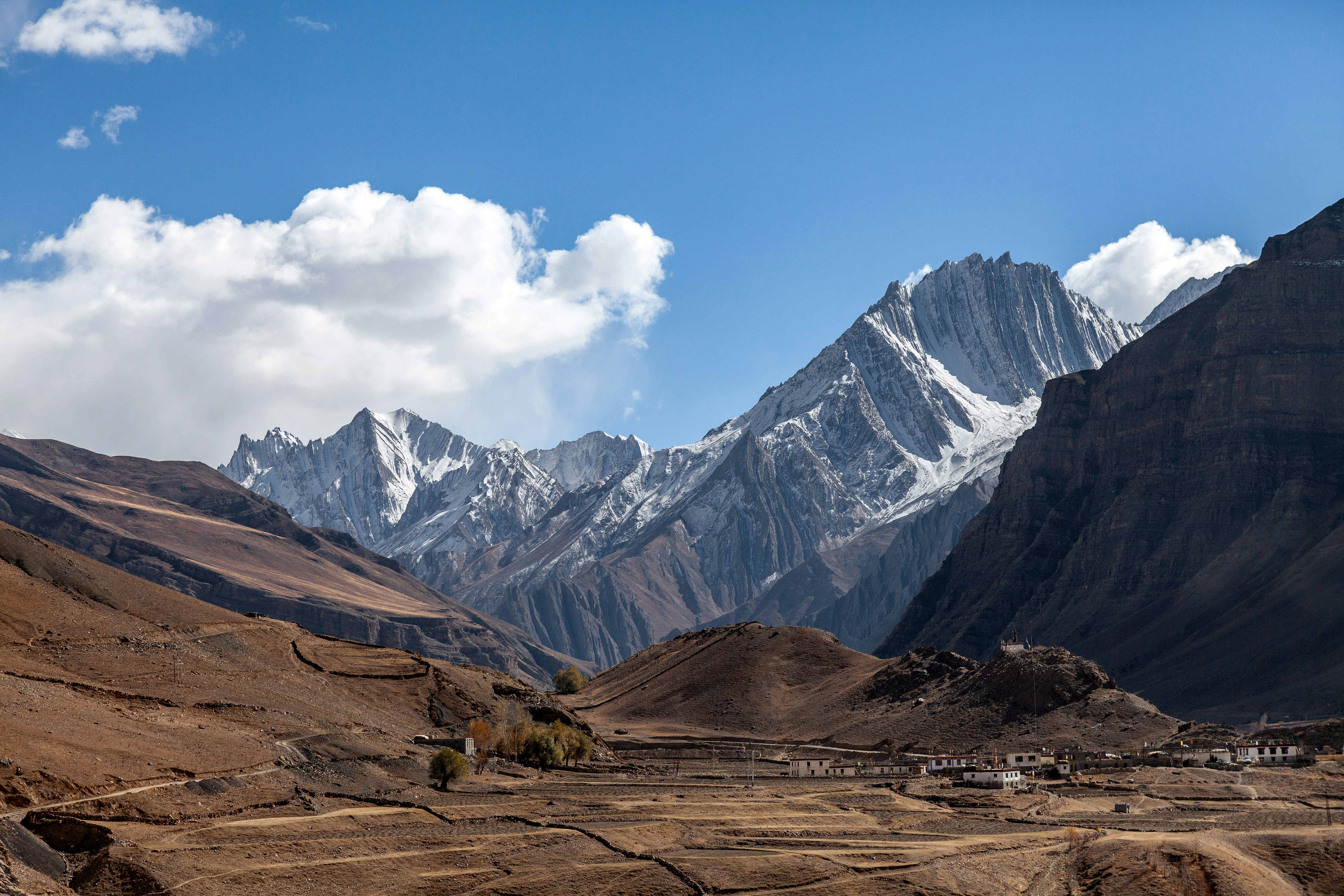 A view of a mountain range with a village in the foreground
