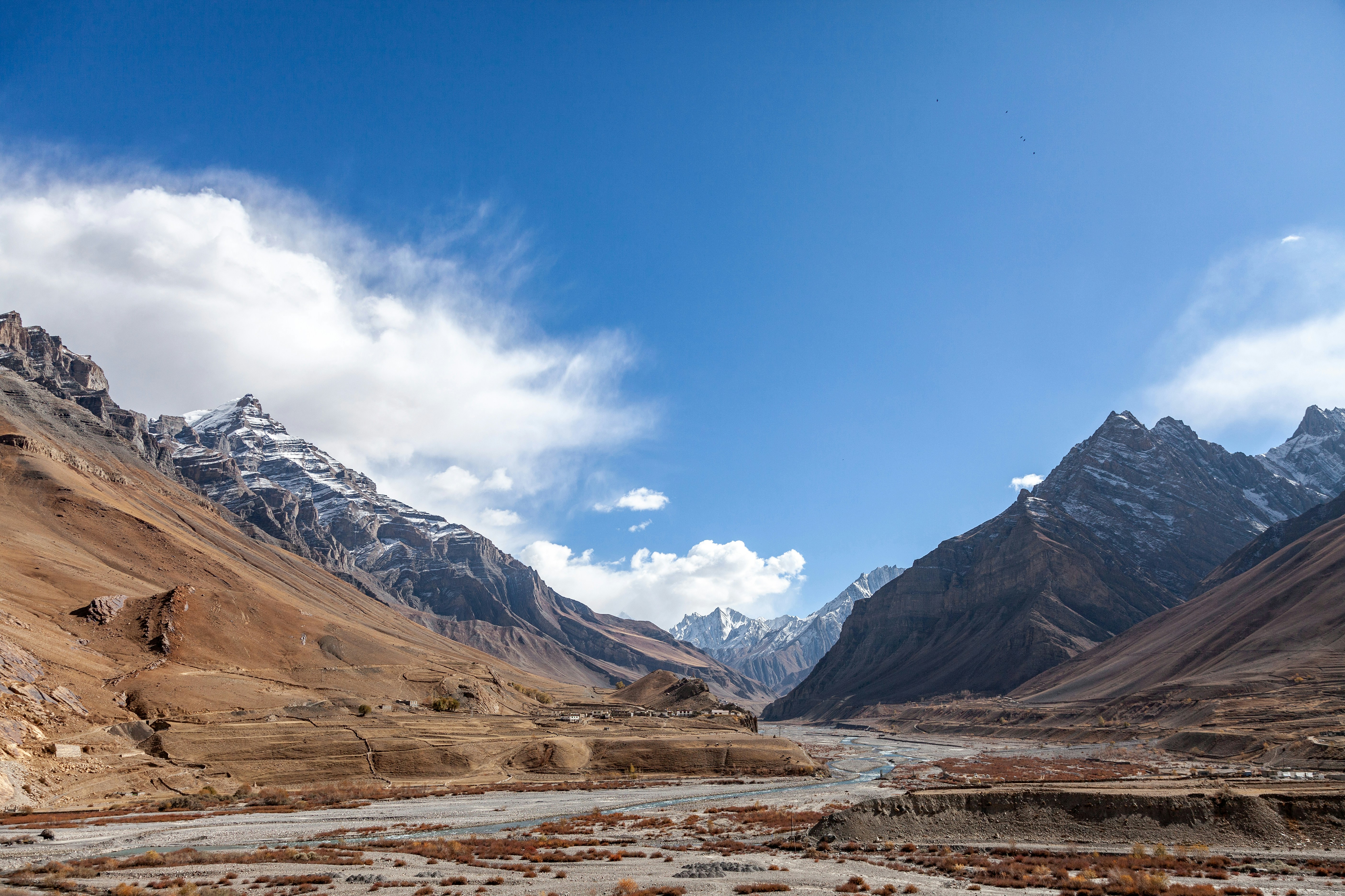 A river running through a valley surrounded by mountains