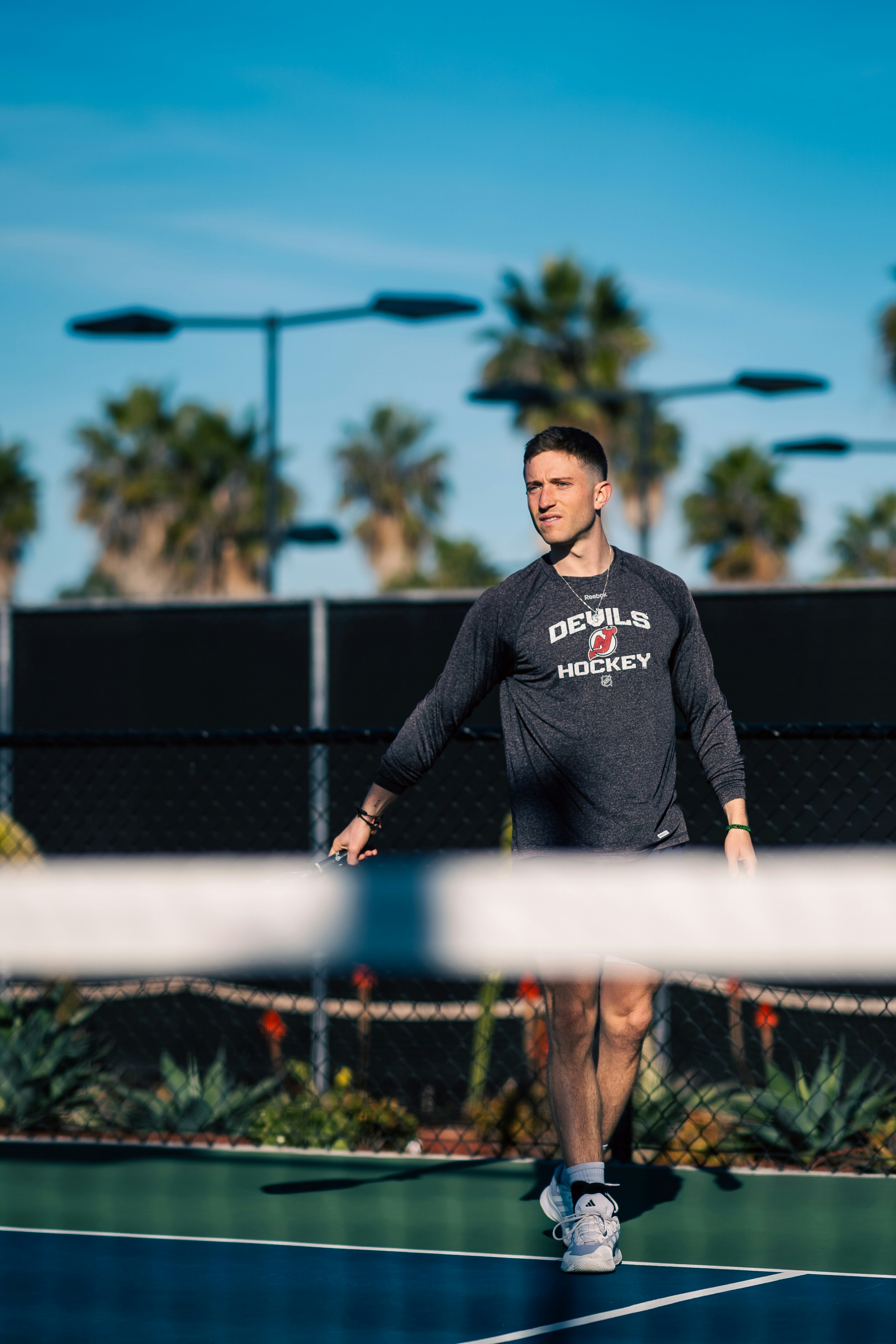 A man standing on a tennis court holding a racquet