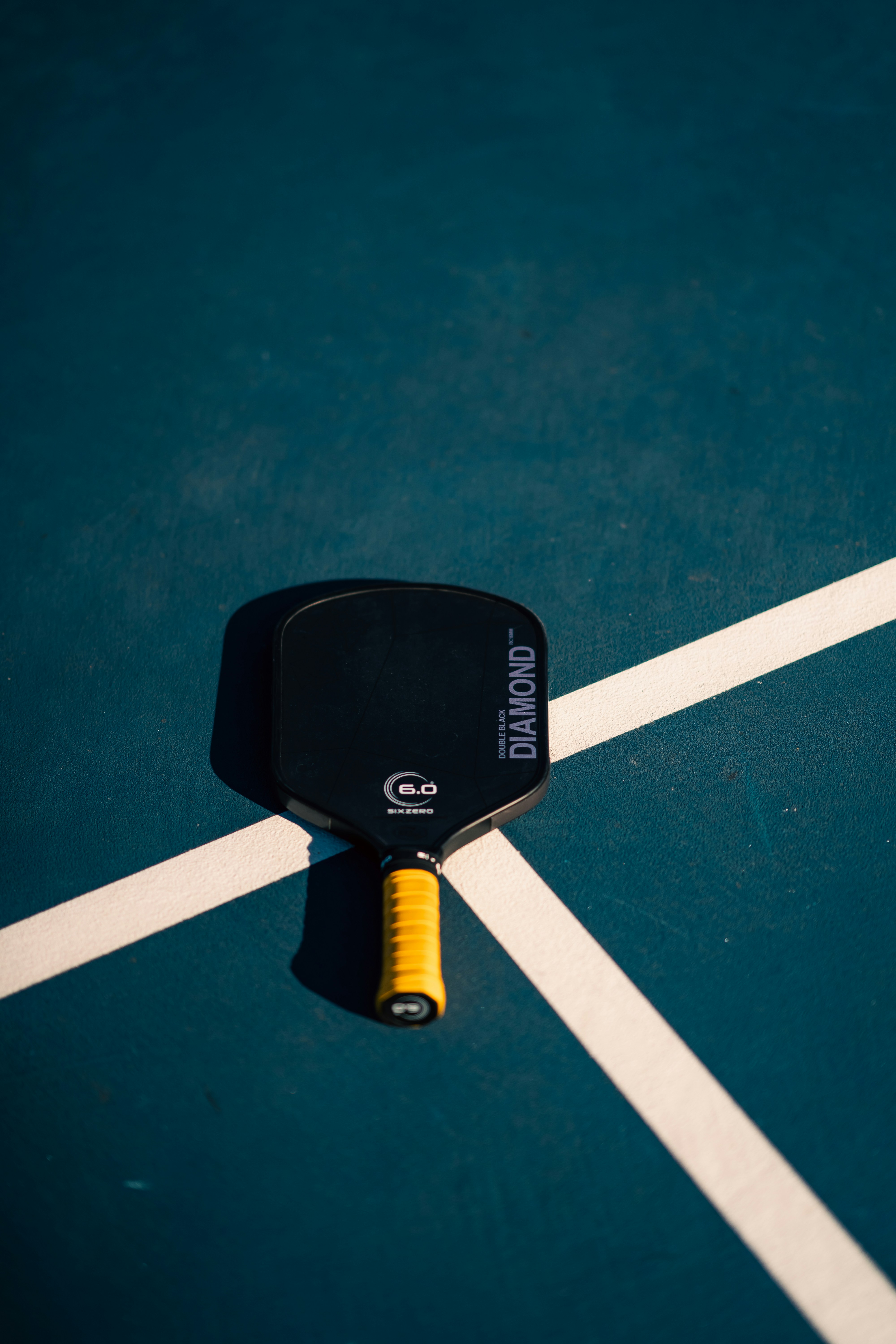 A tennis racket and ball on a tennis court