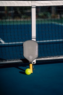 A tennis ball and racket on a court