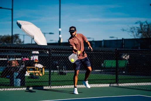 A man on a tennis court holding a tennis racket