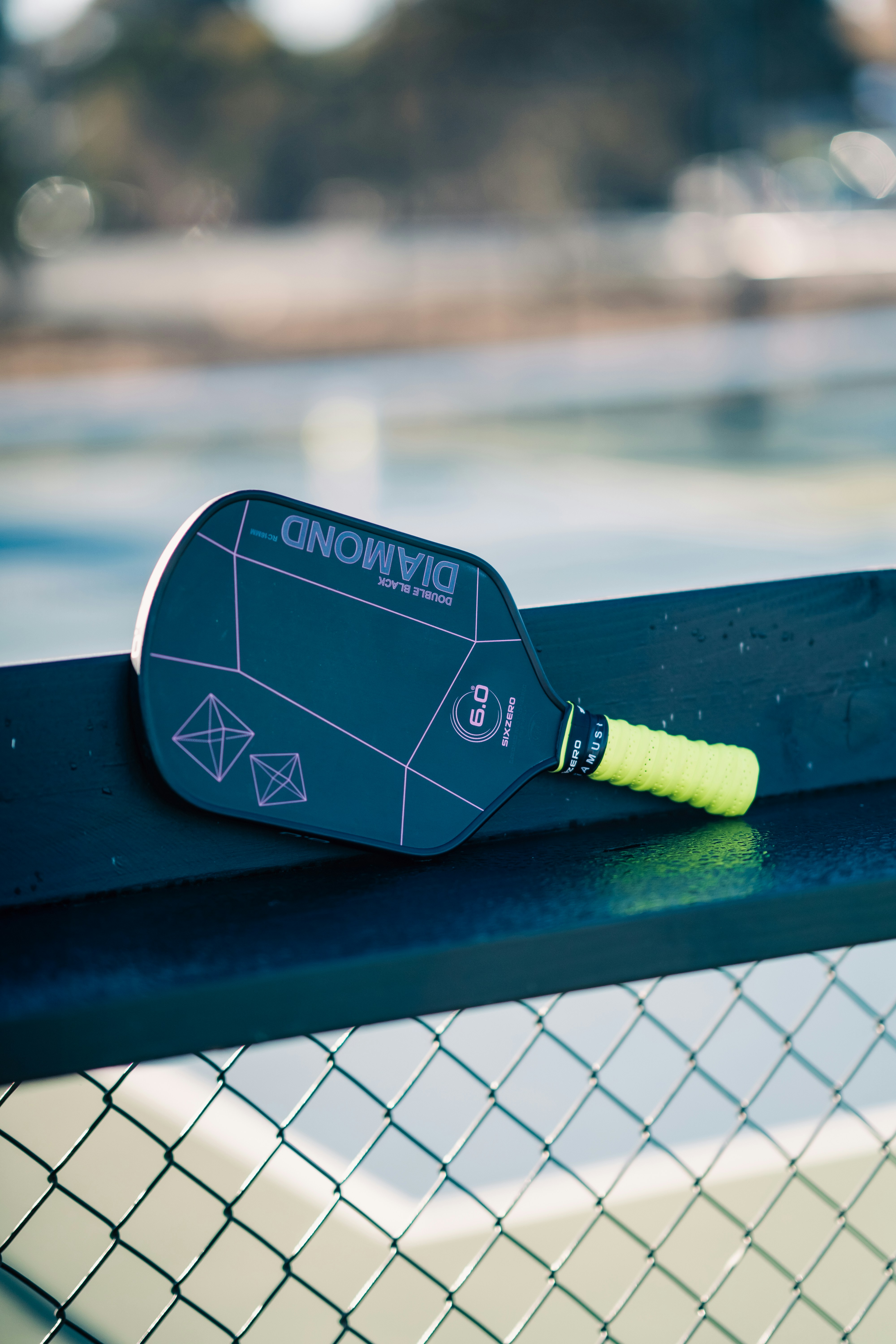 A tennis racket resting on a tennis net