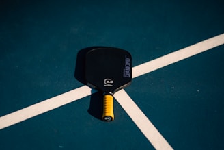 A close up of a tennis racket on a court